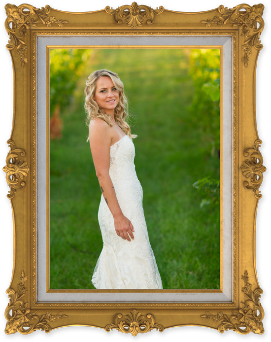 Bride in white dress against green pasture
